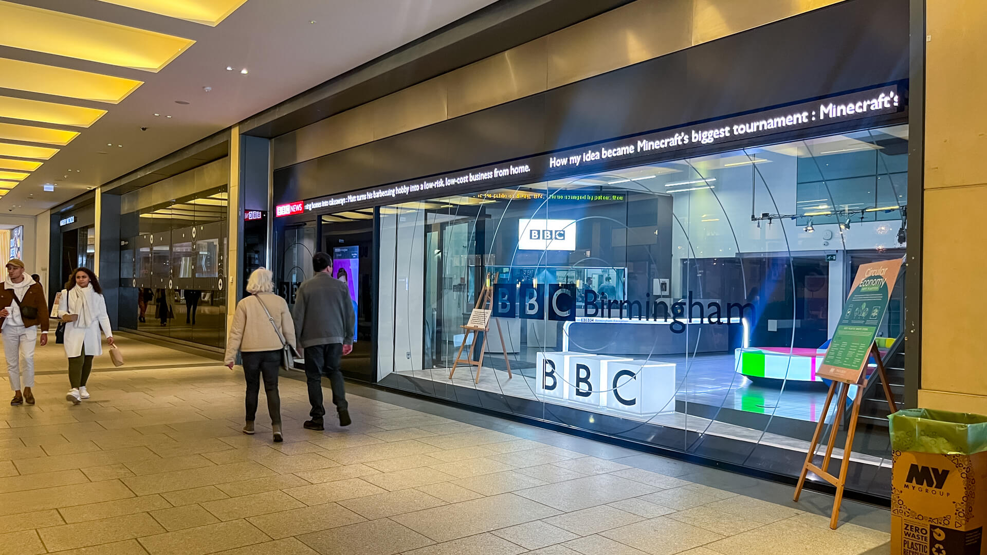 Exterior view of BBC Birmingham in the Mailbox with people walking by.